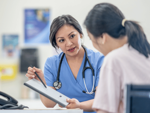 Female doctor discusses health screening results with a patient during a professional medical consultation